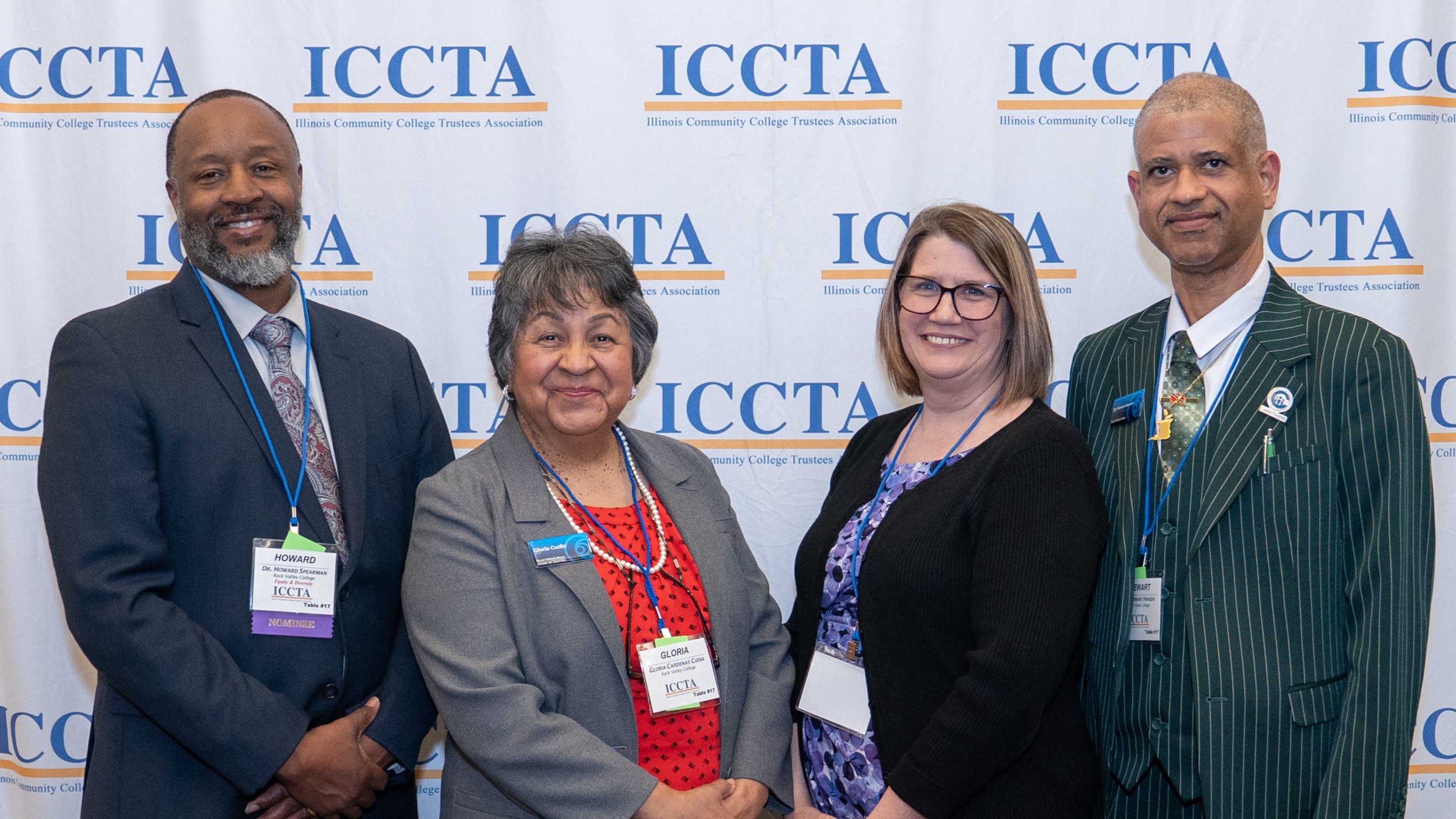 image of four ICCTA members in front of an ICCTA-logo banner