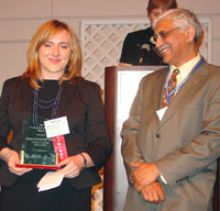Marija Zivanovic-Smith accepts her 2006 Distinguished Alumnus Award, accompanied by College of DuPage president Sunil Chand.