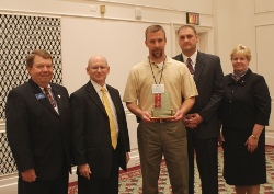 ICCTA vice president David Harby (left) congratulates Richland Community College officials Doug Brauer (second from left) and Kathy Carter (far right) and IBEW representatives Jason Drake (center) and Shad Etchason on earning ICCTA's 2010 Business/Industry Partnership Award.