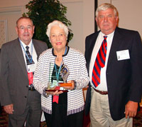 Margot McAfoos accepts ICCTA's 2006 Lifelong Learning Award from Rend Lake College trustee Marvin Scott (left) and president Mark Kern.