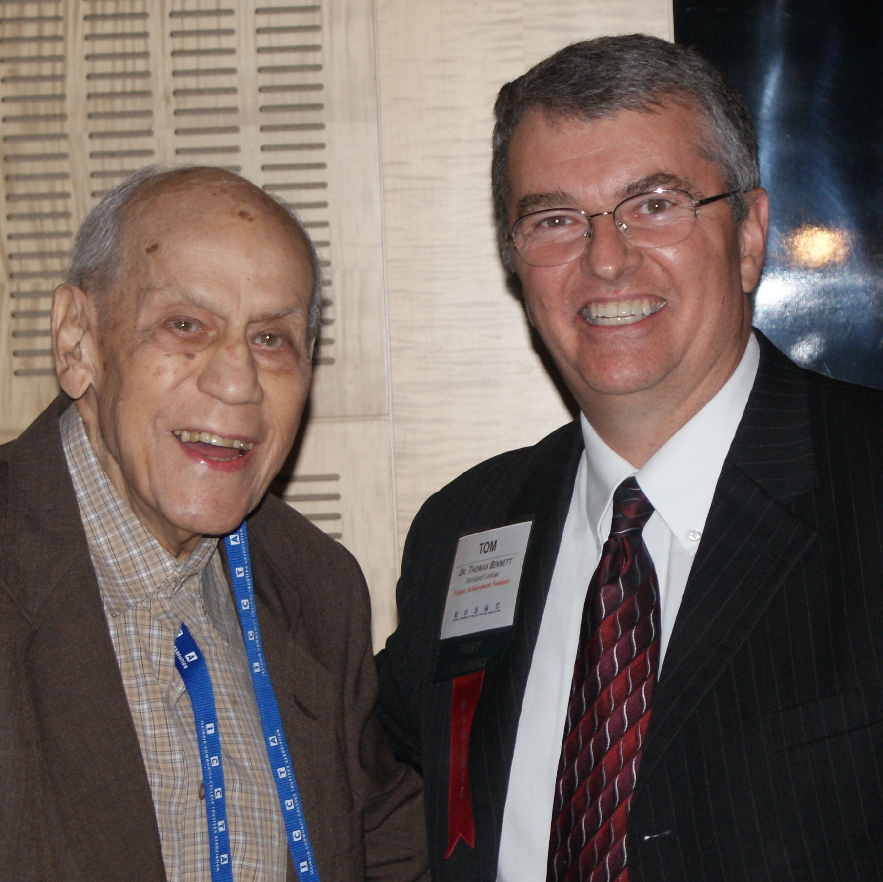 Dr. Tom Bennett receives ICCTA's 2013 Ray Hartstein Trustee Achievement Award from award namesake Ray Hartstein.