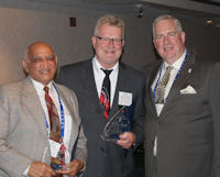 Jody Wadhwa (left) and Richard Anderson (center) receive their 2014 ICCTA Ray Hartstein Trustee Achievement Awards from ICCTA vice president William Kelley.