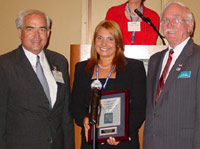 Jill Tomaszewski accepts ICCTA's 2005 Pacesetter Award with Kaskaskia College president Dr. James Underwood and KC chair Jim Beasley.