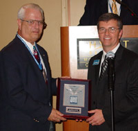 Frank Walker (left) accepts his Certificate of Merit from ICCTA vice president Tom Bennett.
